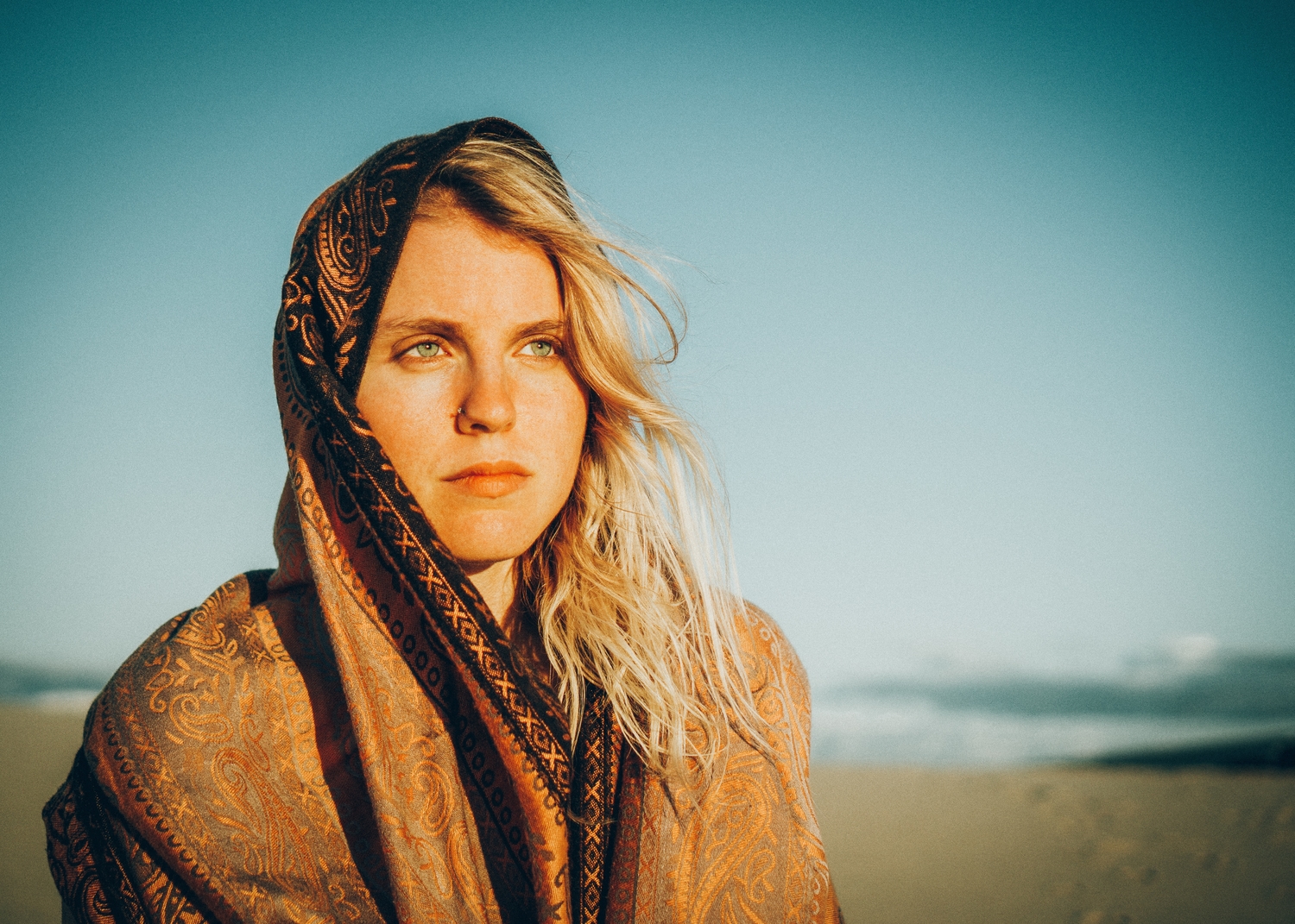 woman at the beach with scarf on her head