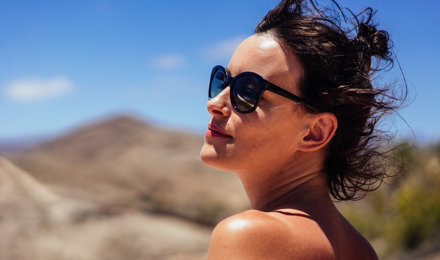 woman in sunglasses sunbathing