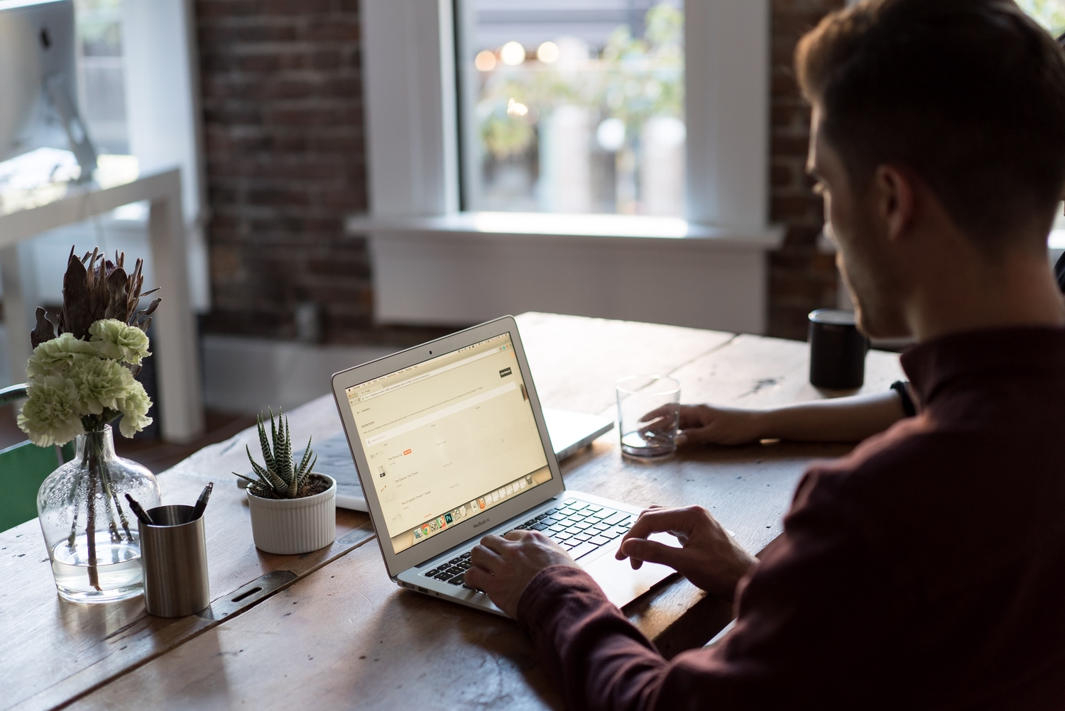 man using laptop on a table