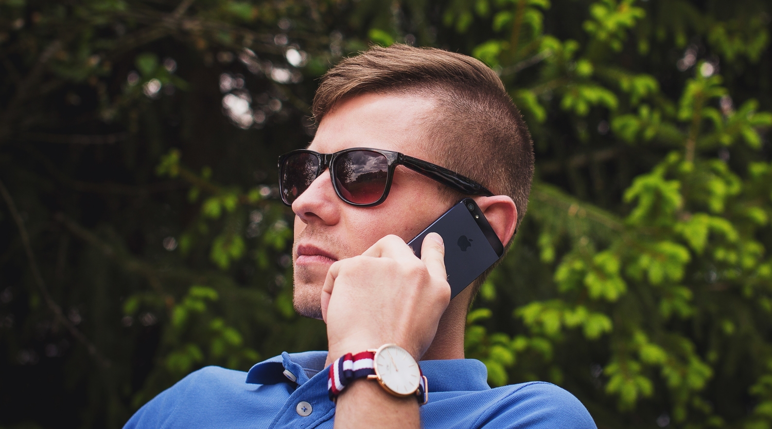 guy in sunglasses talking on the phone