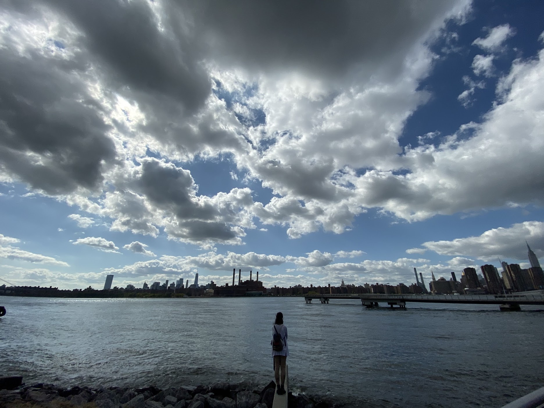 A wide watery landscape with a person's silhouette