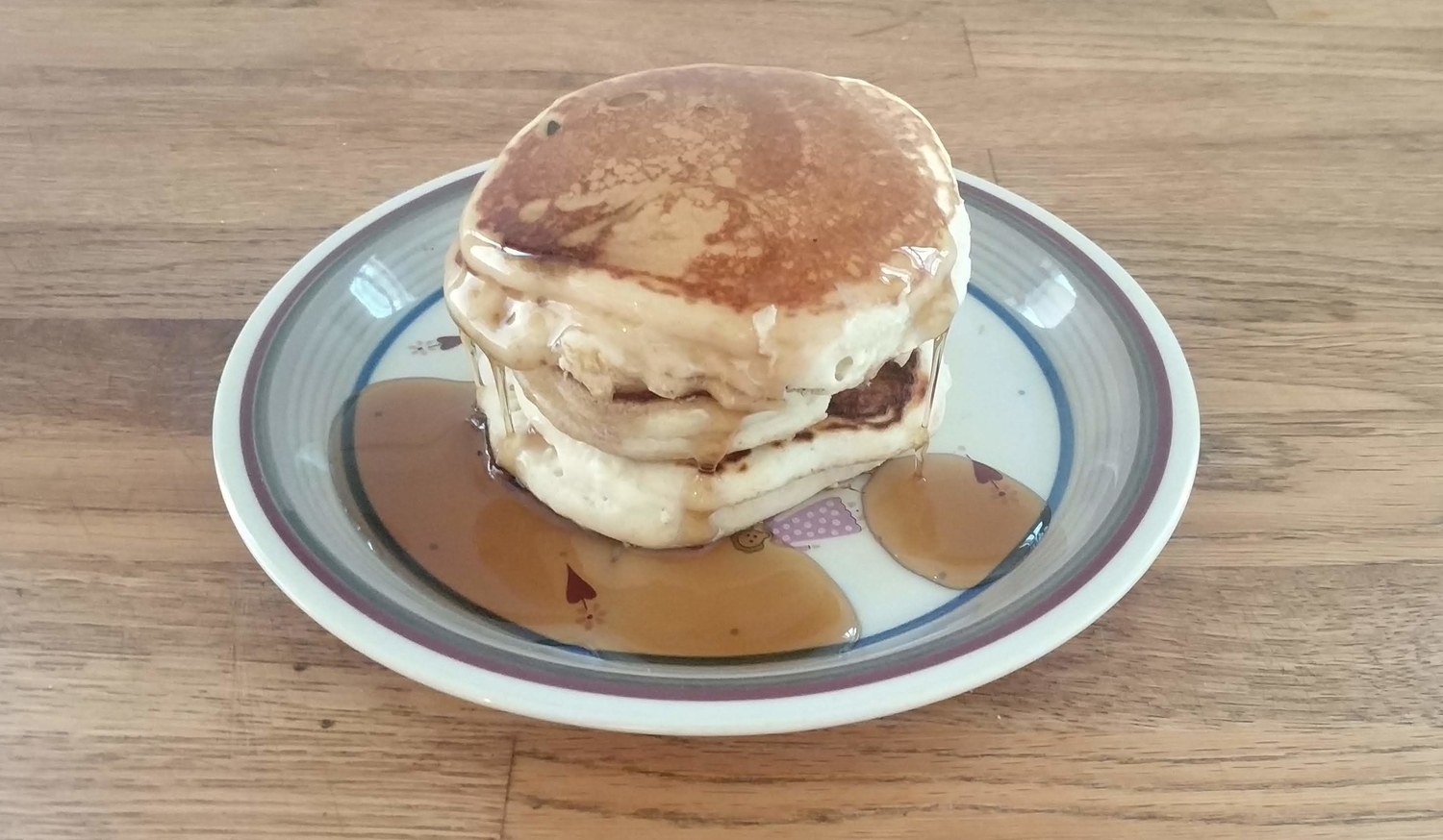 stack of eggless pancakes on a wooden table
