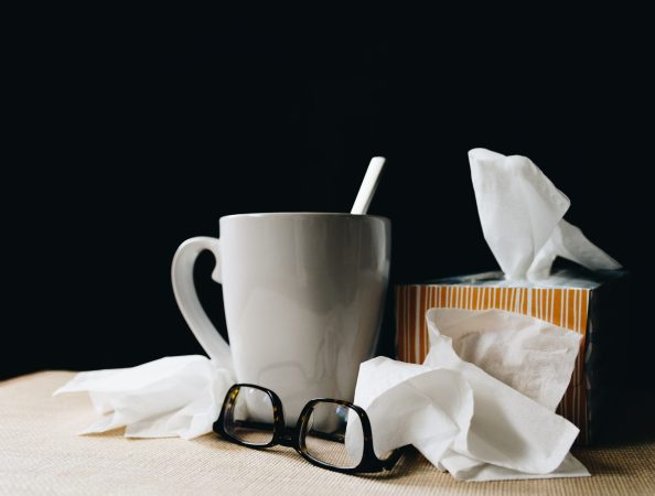 desk with mug and kleenex