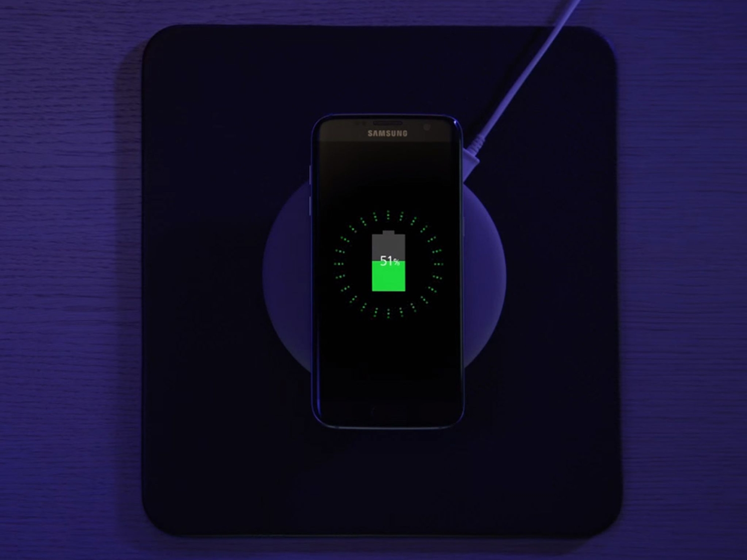 A Samsung phone with a lithium-ion battery charging on a wireless charging pad.