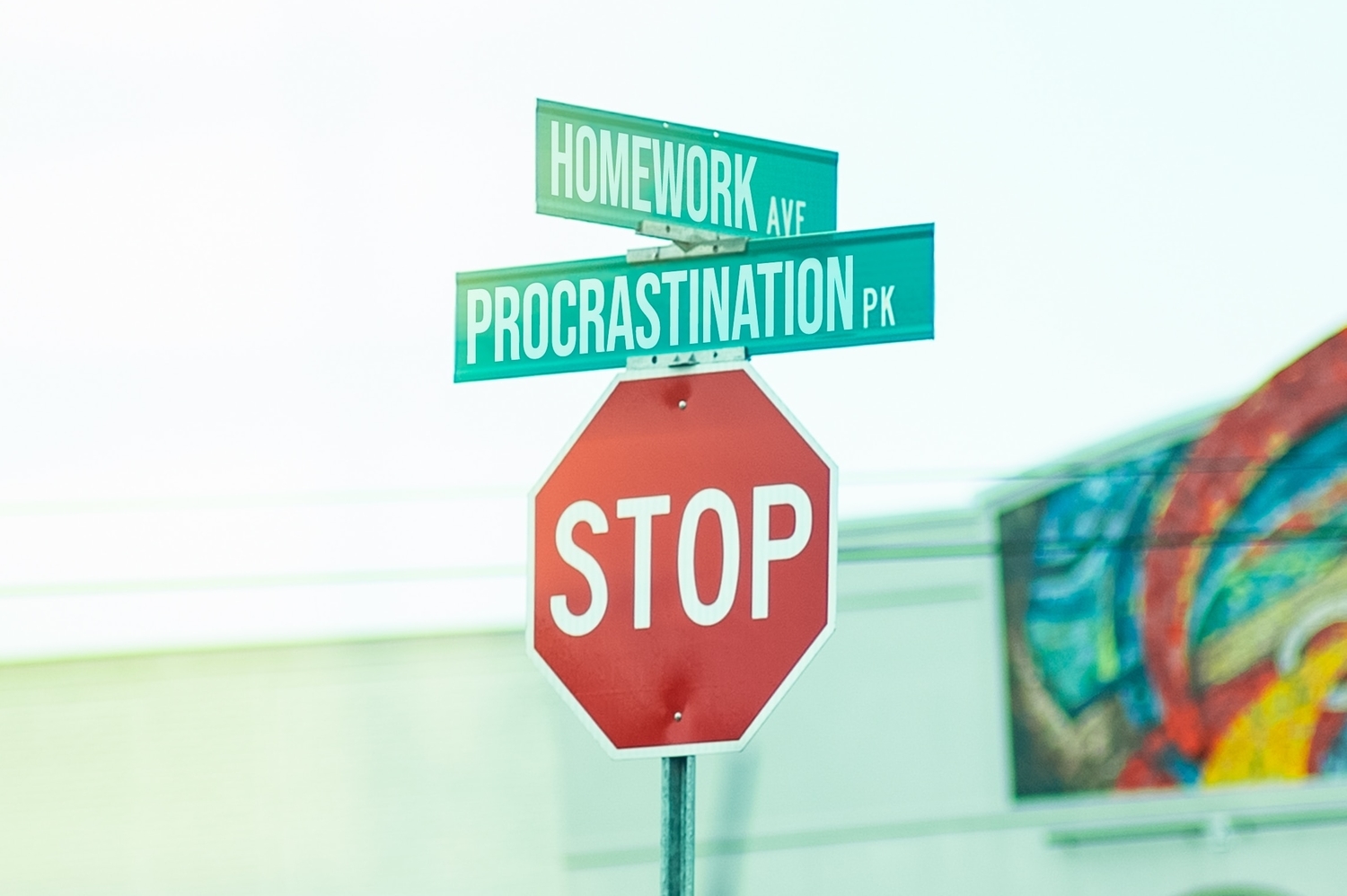 stop sign and street signs reading procrastination and homework