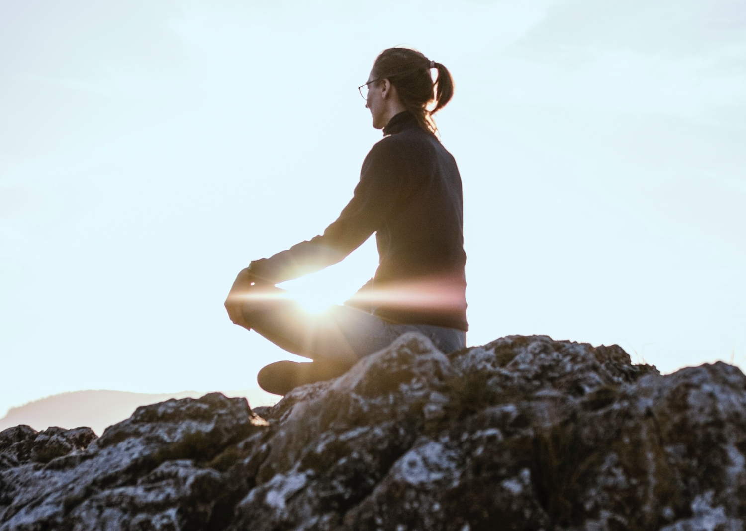 person meditating in a hill top