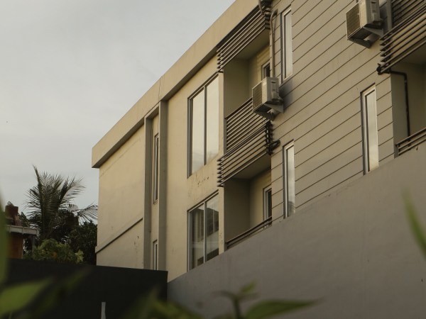 A white apartment building under cloudy skies.