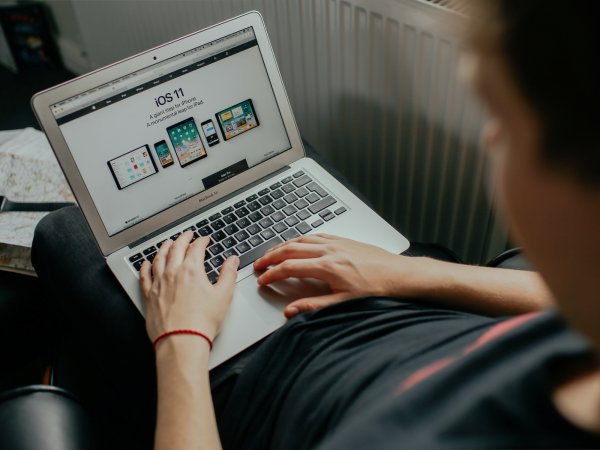 A person using a laptop to look at Apple products on Safari.