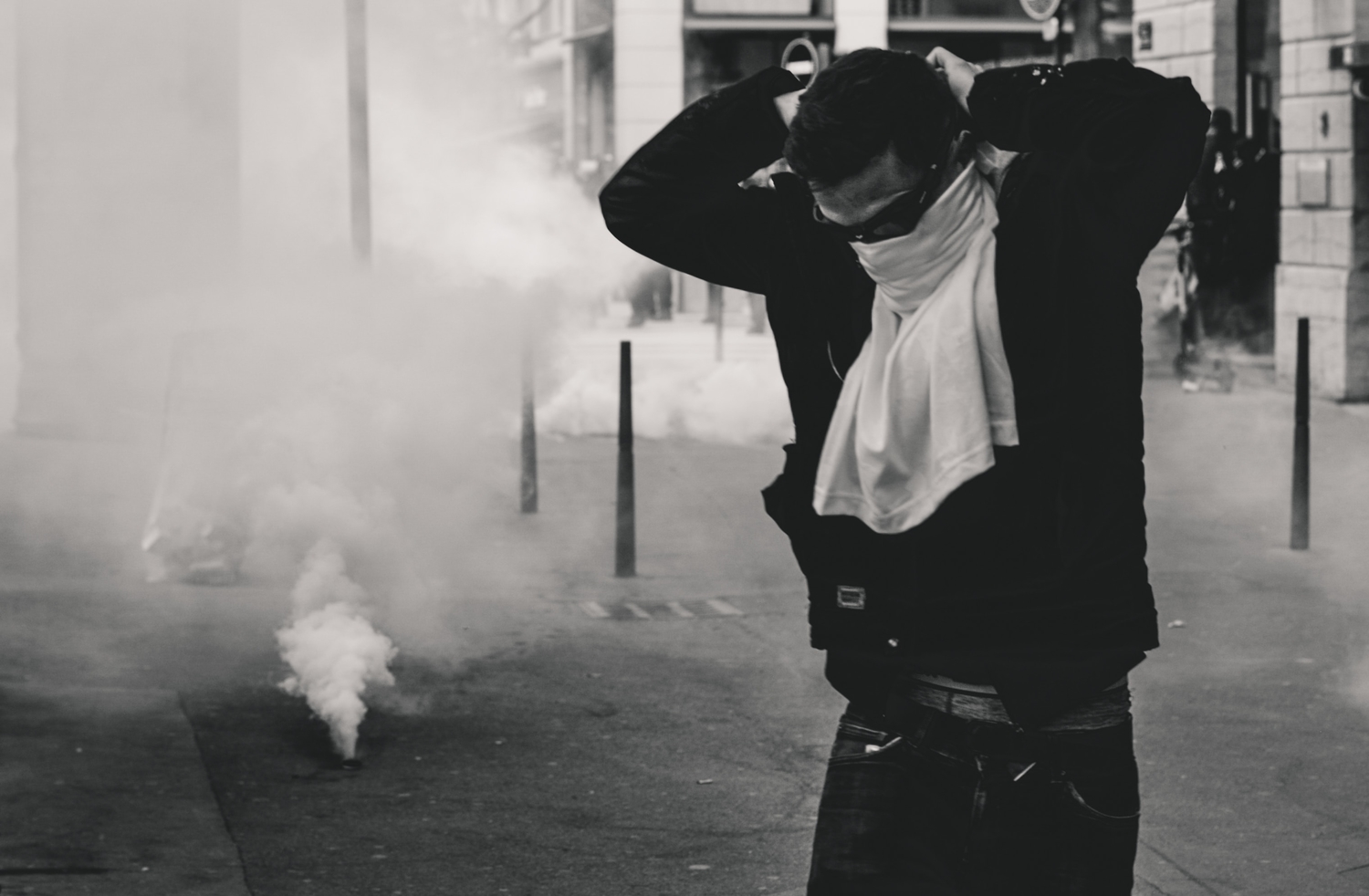 Protester securing a shirt to cover their face