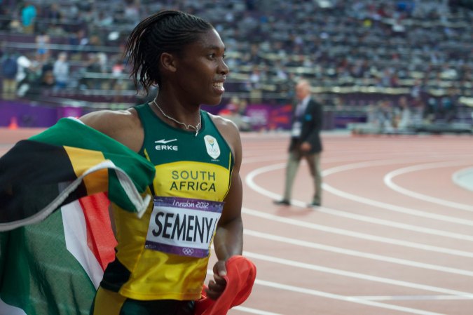 Caster Semenya on track with south african flag around her