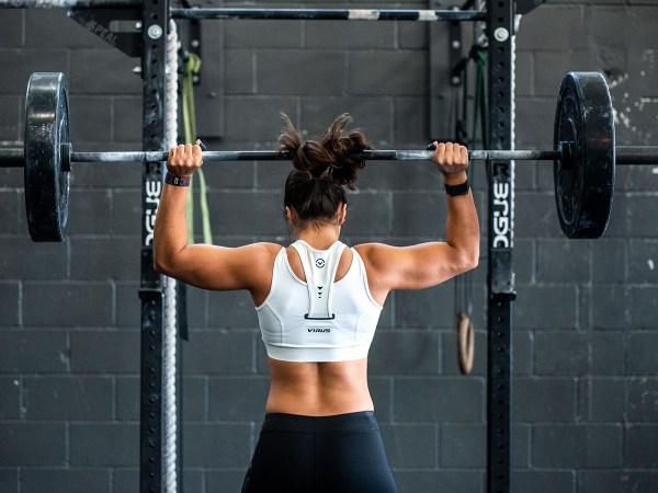 Person lifting weights in a gym.