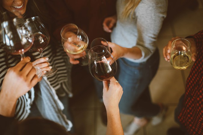 people holding wine glasses