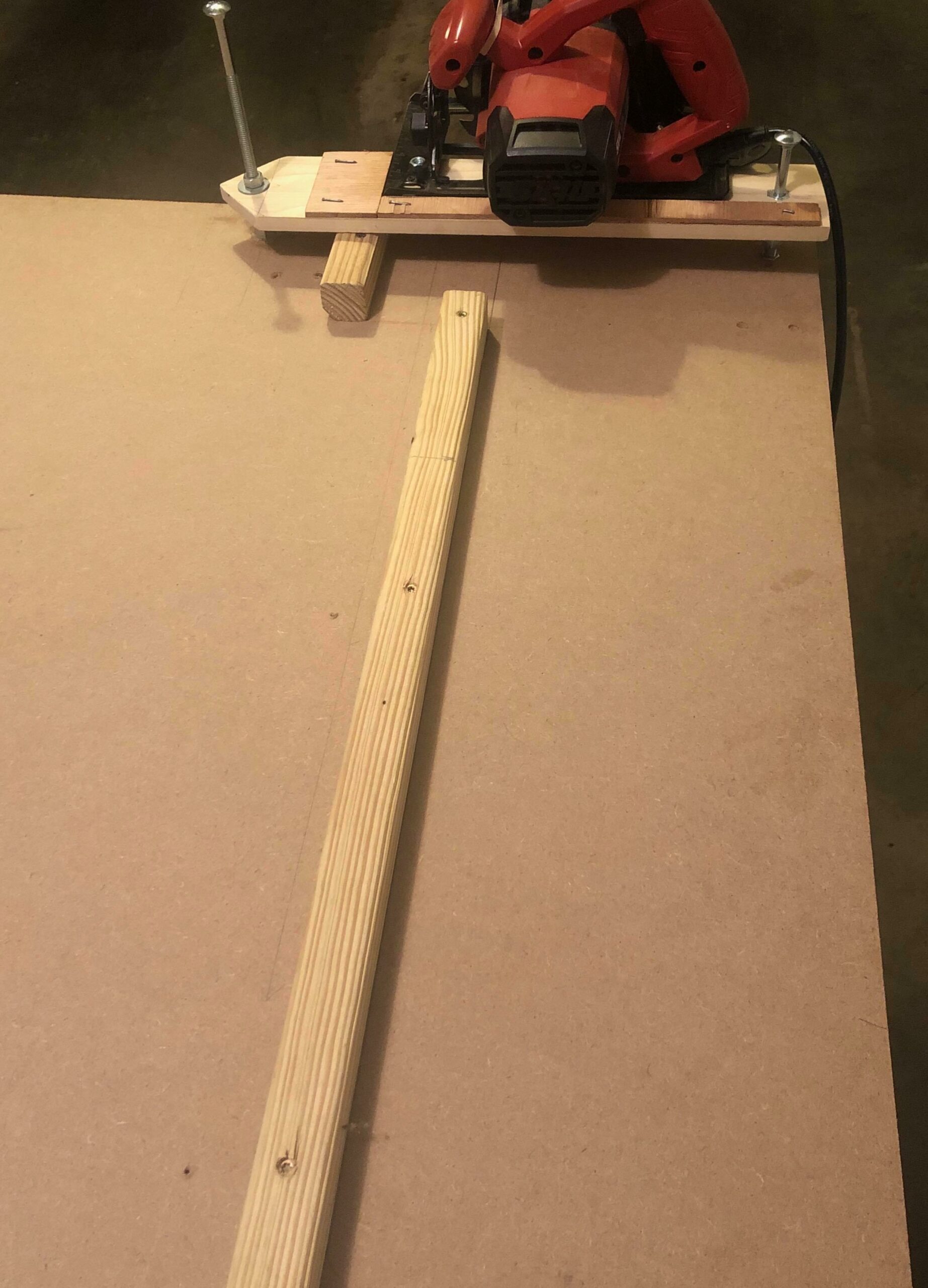 a work surface with a chop saw jig and a wood-cutting guide fence