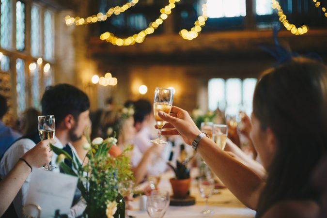 people holding up glasses in a toast