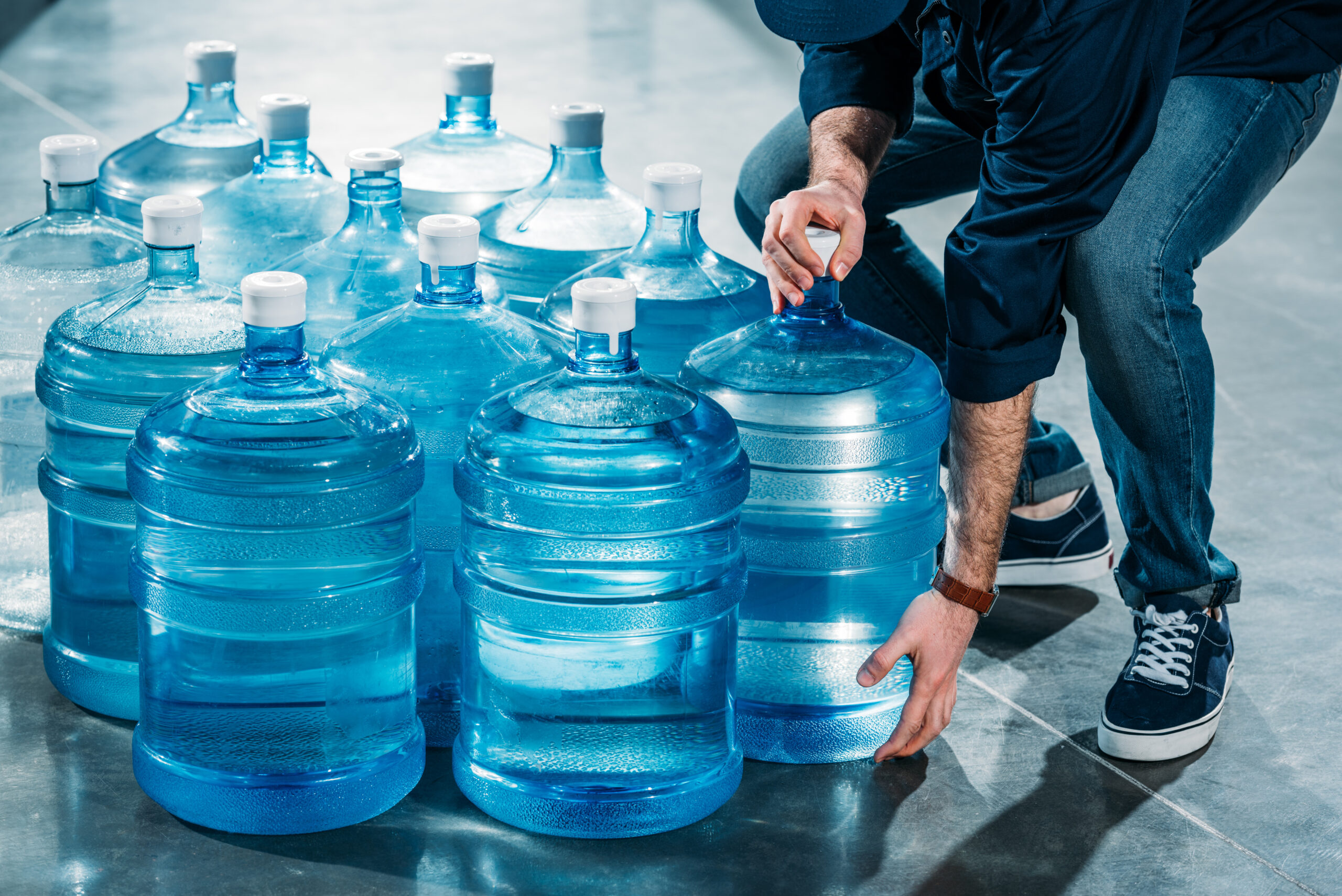 man delivering drinking water in jugs