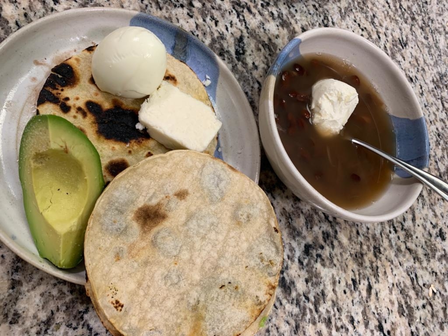 Bean soup served with avocado, cheese and eggs.