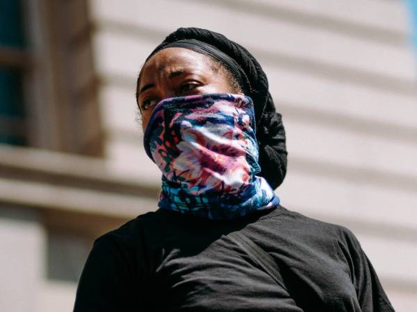 A person using a neck gaiter as a face mask.