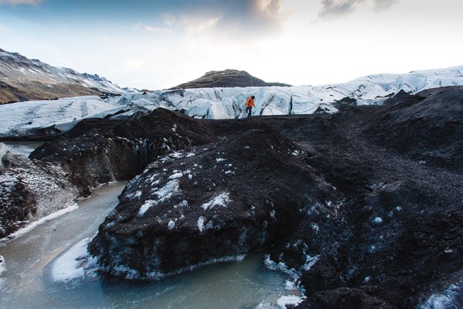 man walking across mountain