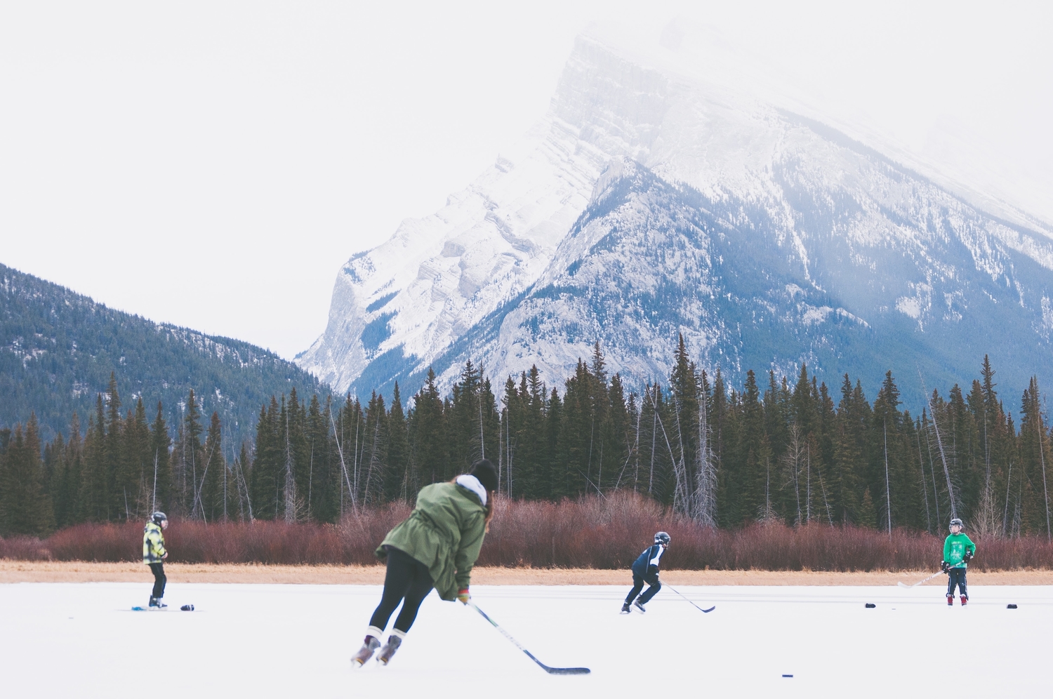 People playing ice hockey outside