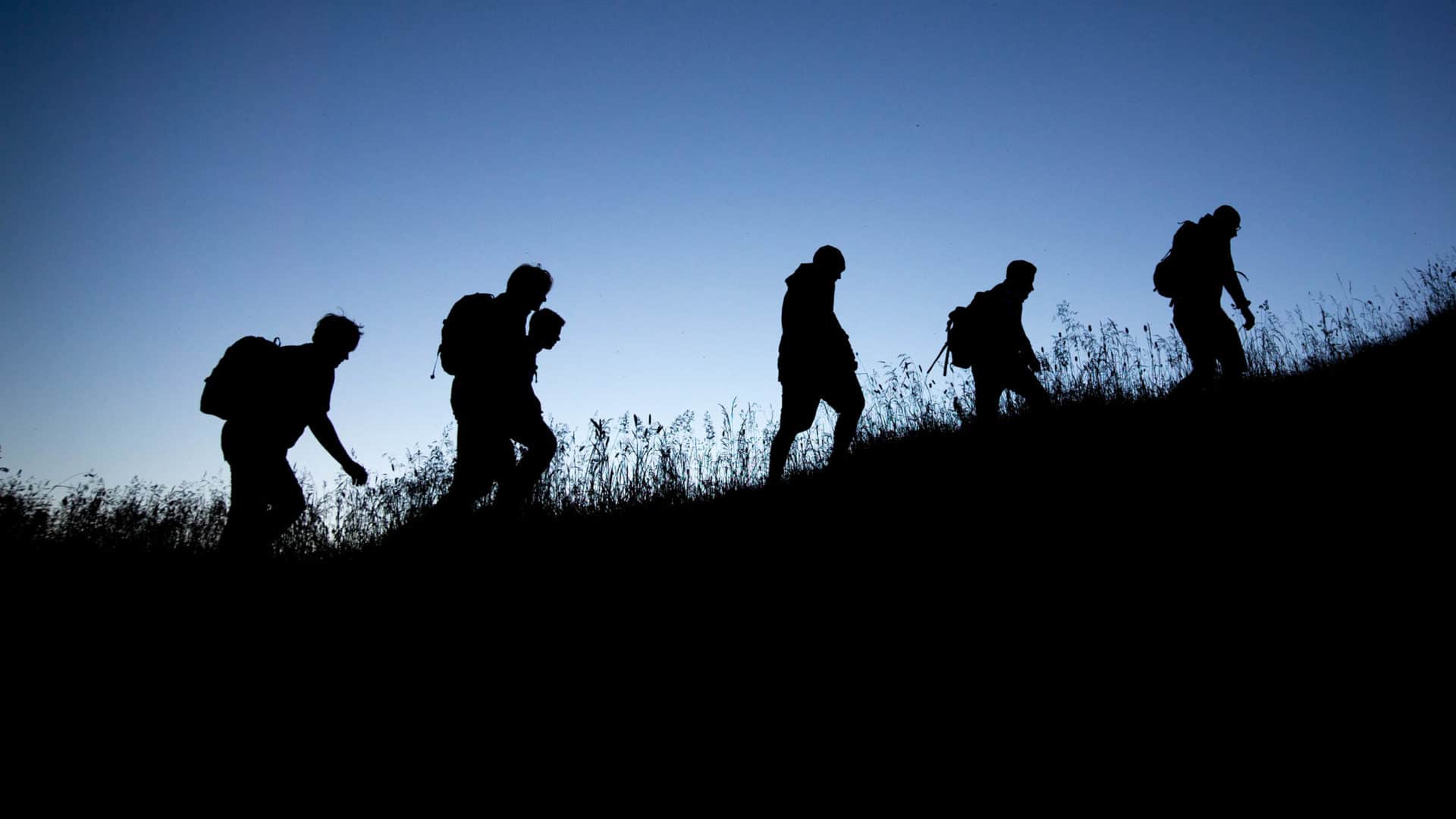 People climbing up a hill