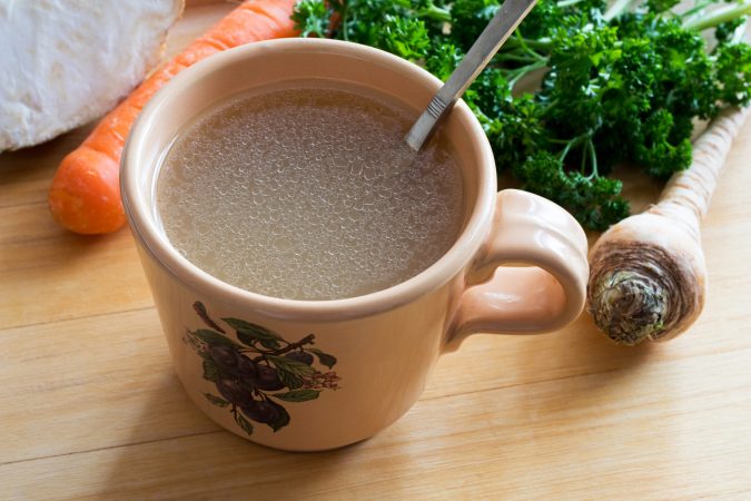 Chicken broth in a mug.