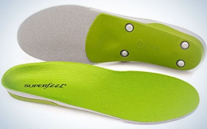  Two soles of light green shoes with a grey on top of them.