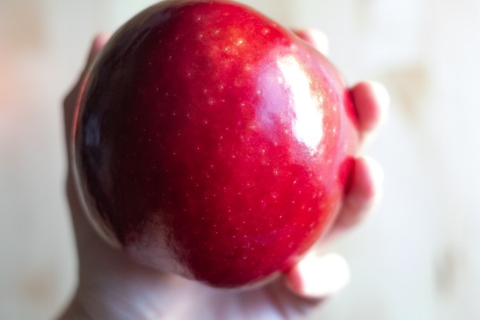 Hand holding an apple