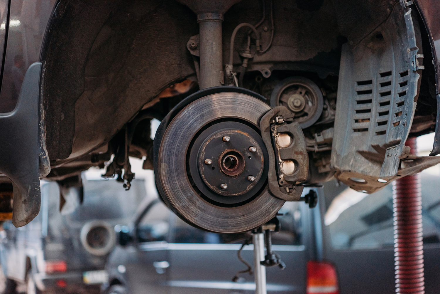 a brake rotor on a partially disassembled car