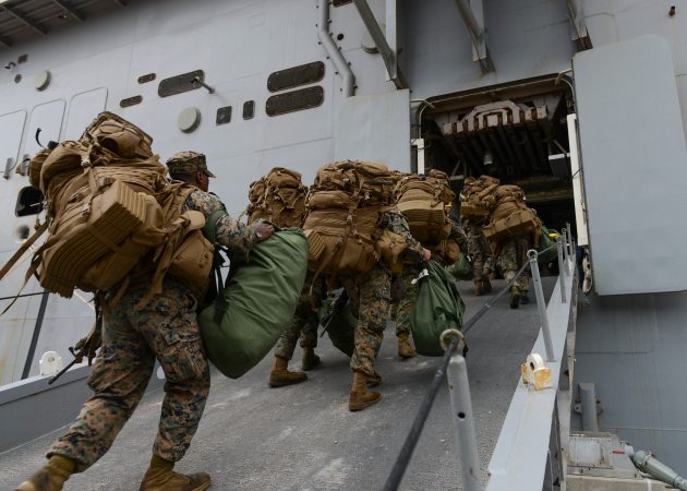 Marines board the amphibious assault ship USS Iwo Jima