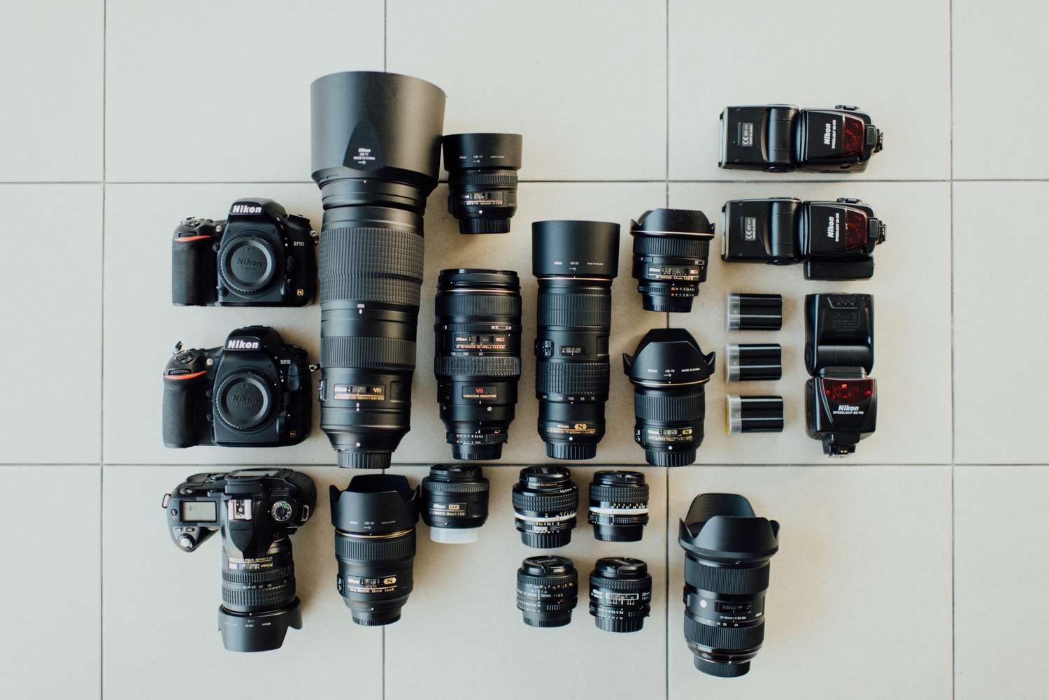 Cameras and photolenses spread on the floor