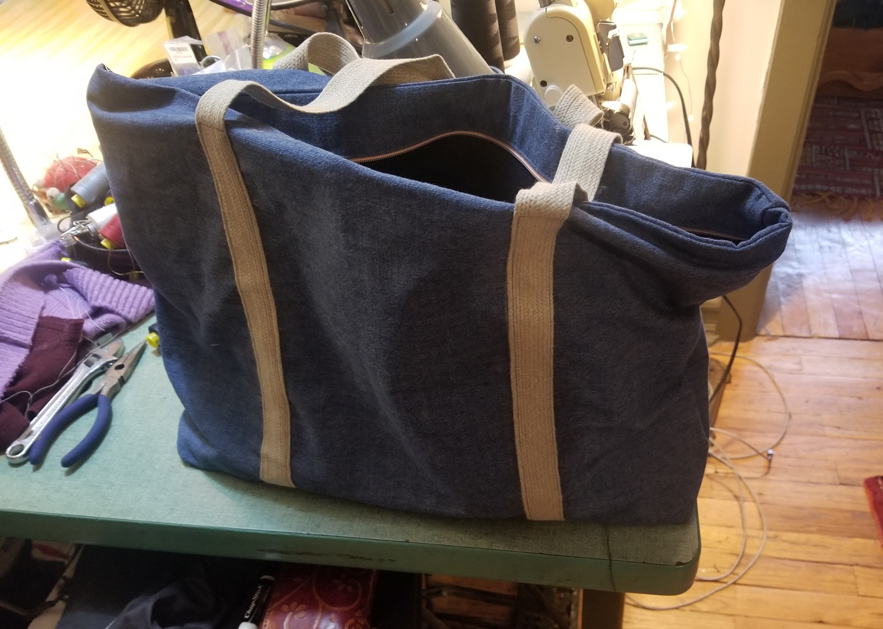 a DIY zippered tote bag made out of recycled fabric