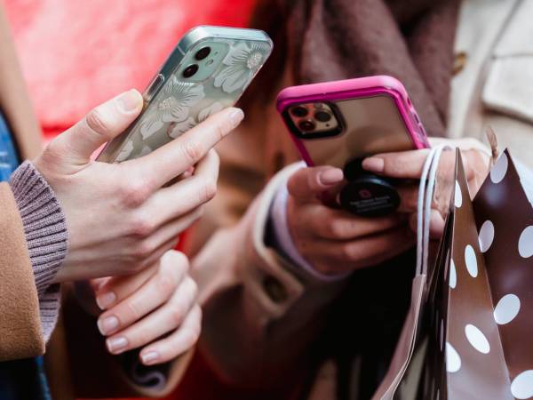 close up to hands holding phones