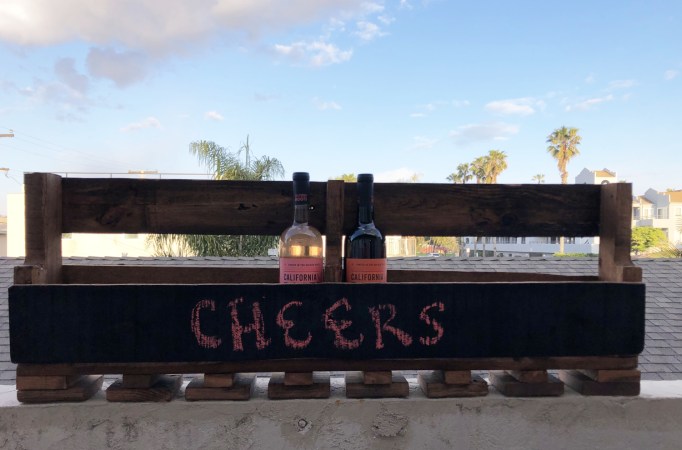 a wine rack made out of a reclaimed wooden pallet