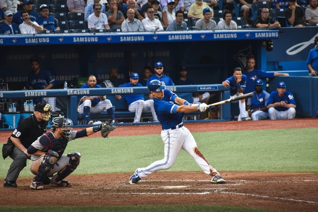 a baseball player swings a bat