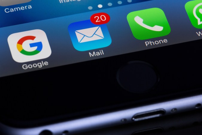 a phone with the Apple Mail app visible, with some notifications