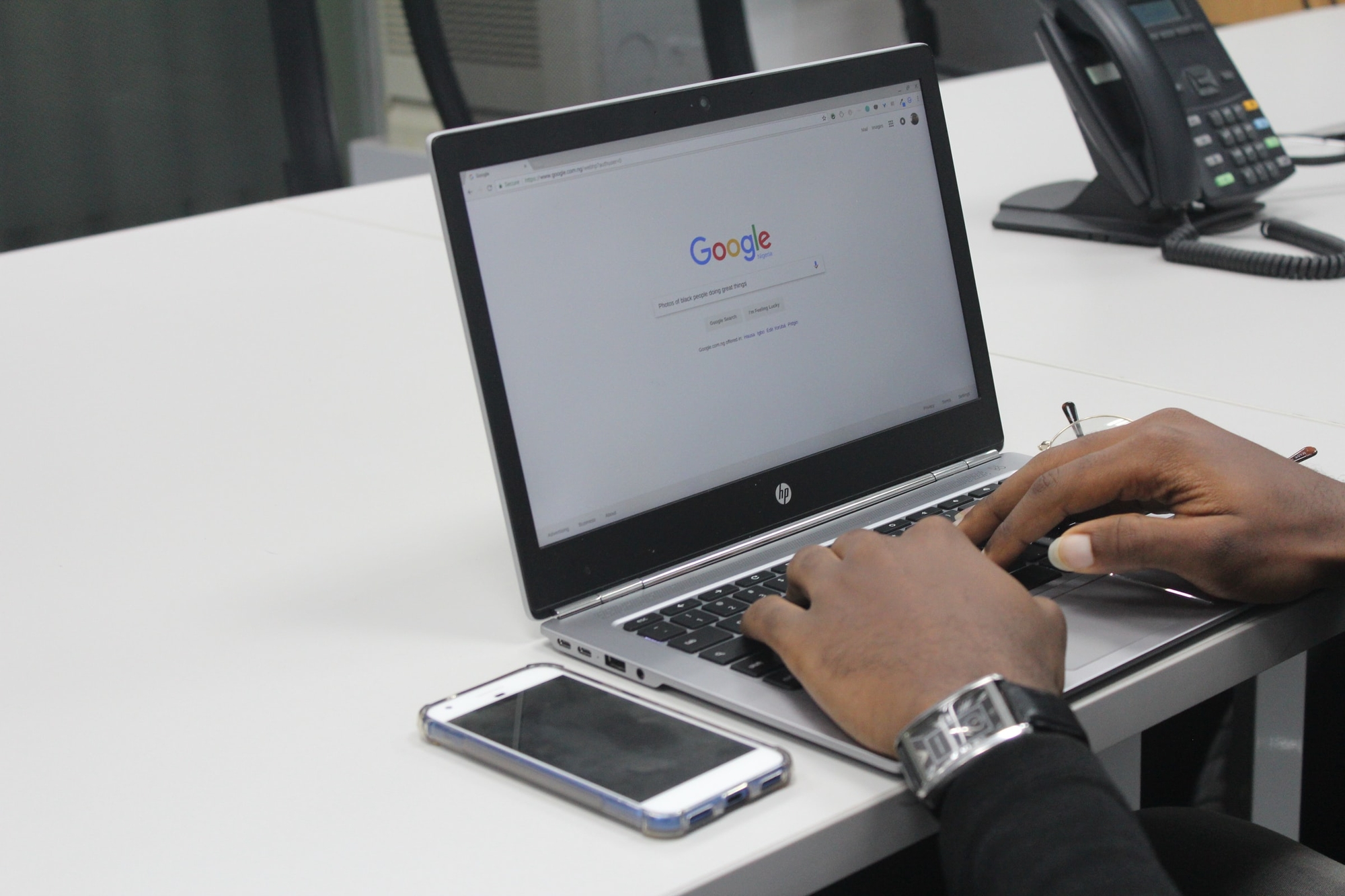 a person using the Google search engine on a laptop