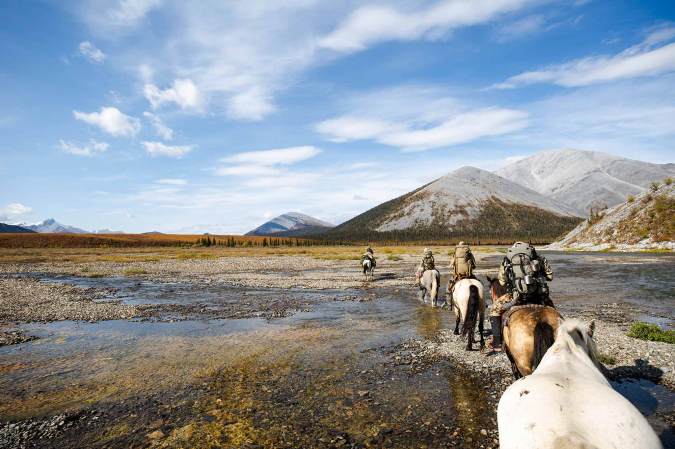 American hunters on horseback through the Yukon