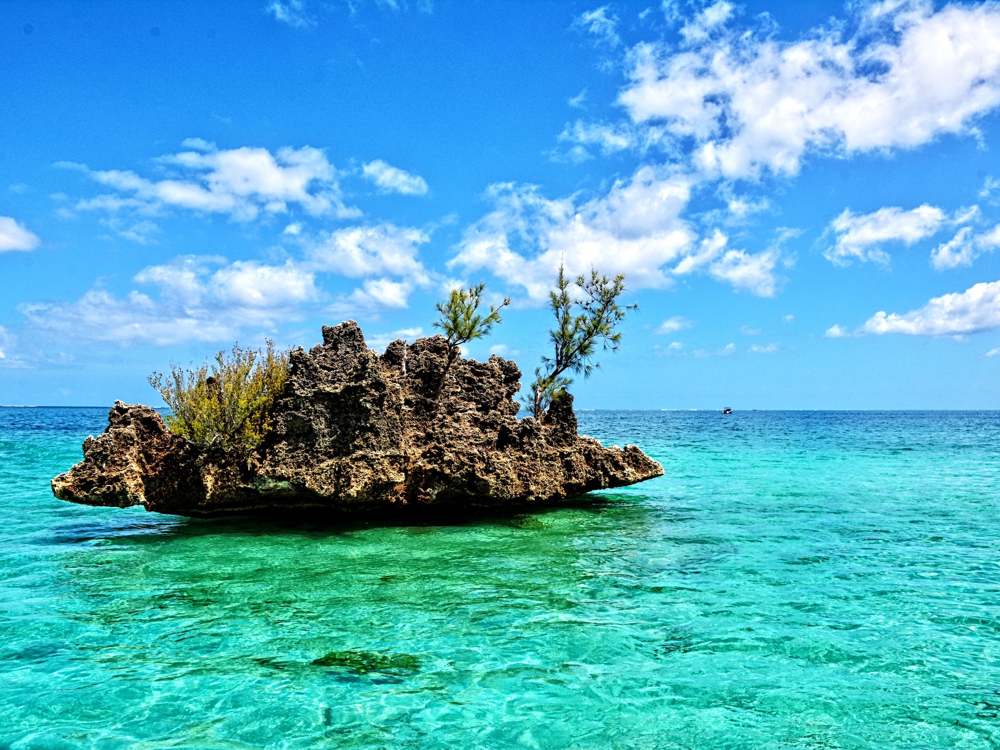 rocky outcropping in very blue tropical waters