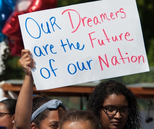 A DACA supporter holds up a sign saying, "Our dreamers are the future of our nation"