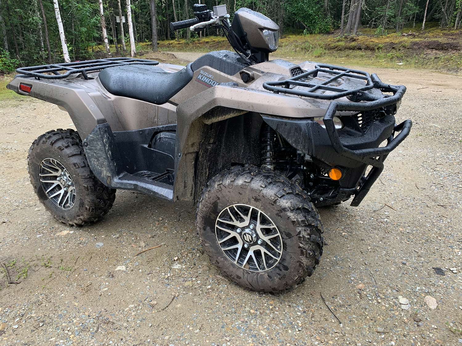 A Suzuki ATV four-wheeler on a rocky path.