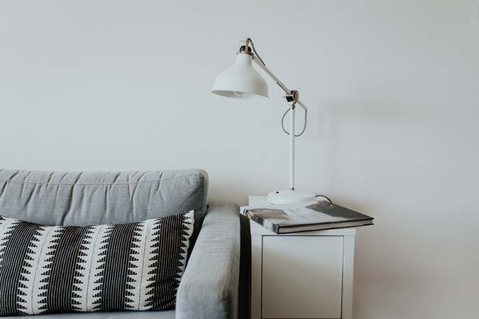 couch and side table with light on it