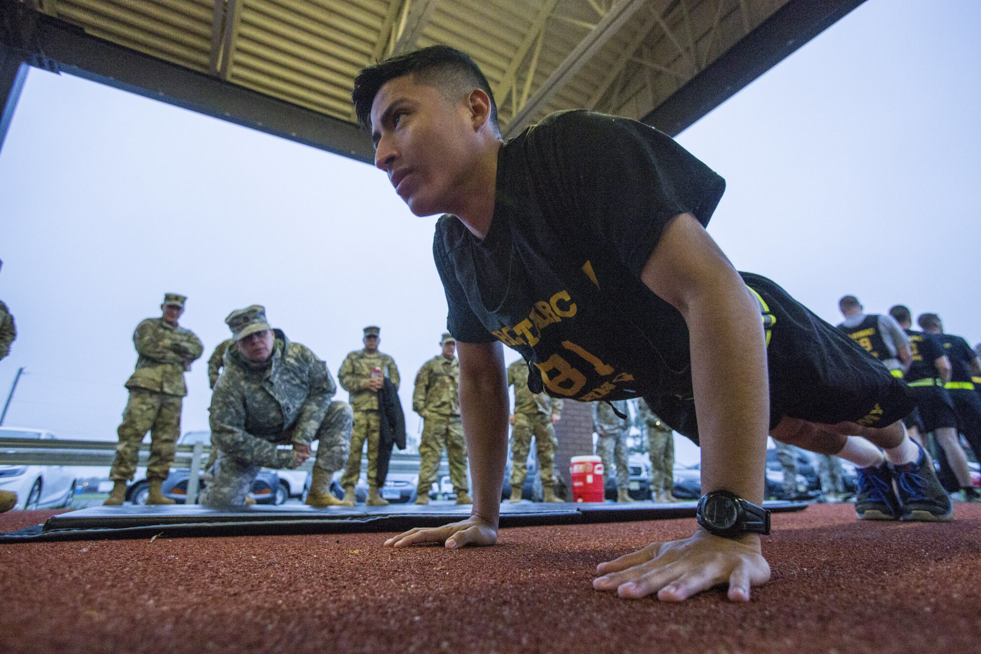 A US Army National Guard soldier does a push-up in front of a drill sergeant