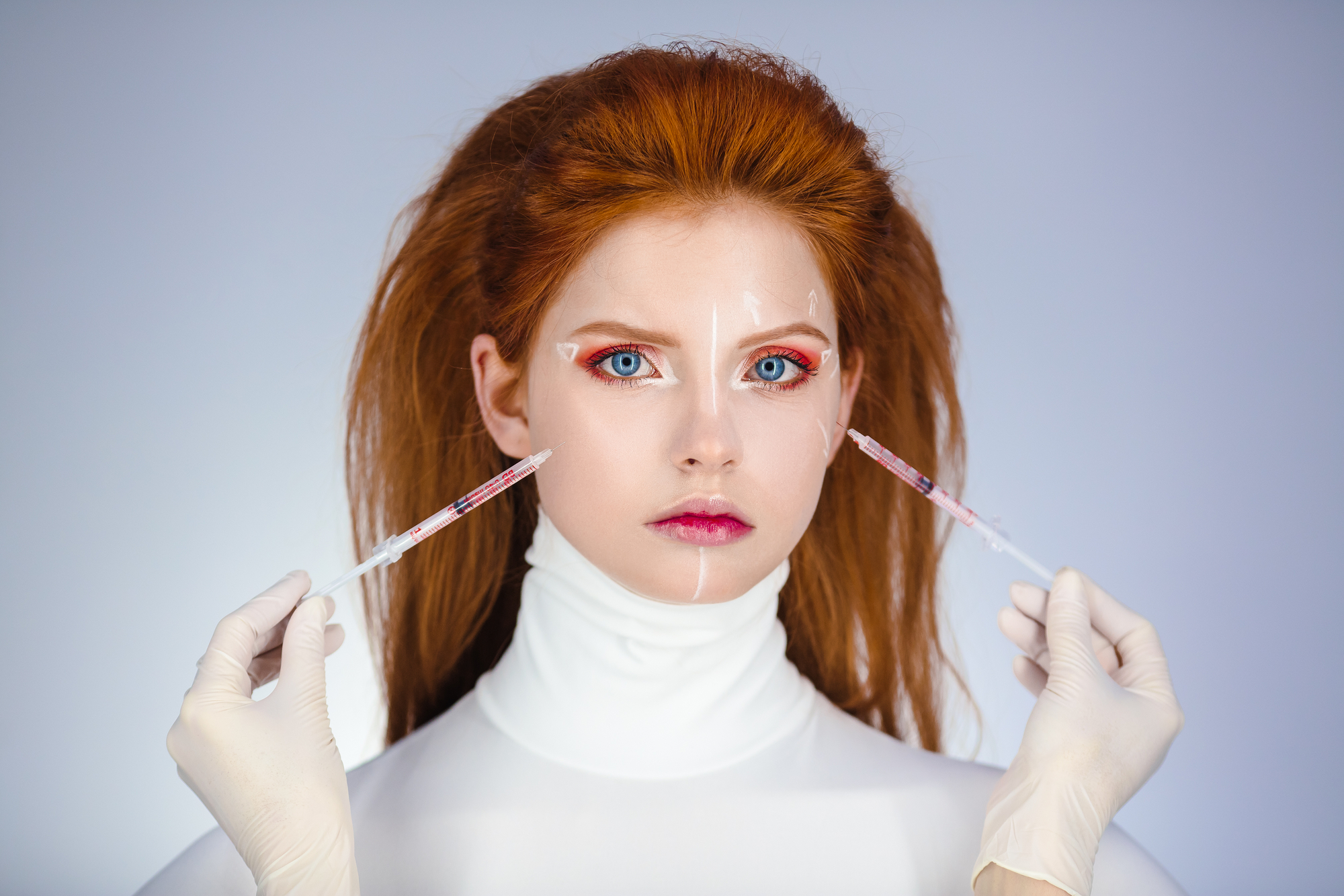 A conceptual botox procedure on a red-haired model