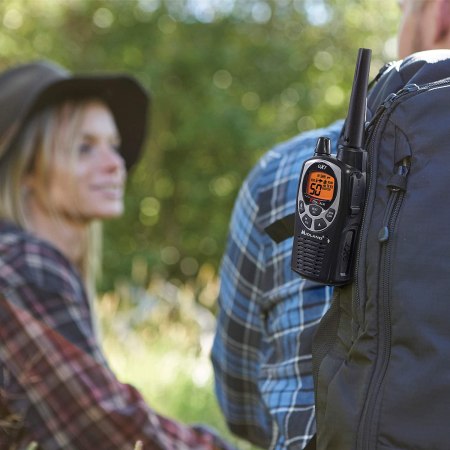 person with walkie talkie on backpack