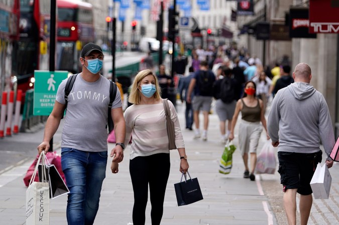 Couple walking while wearing masks