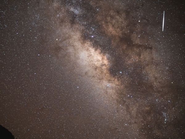 A meteor streaking through a sky full of stars