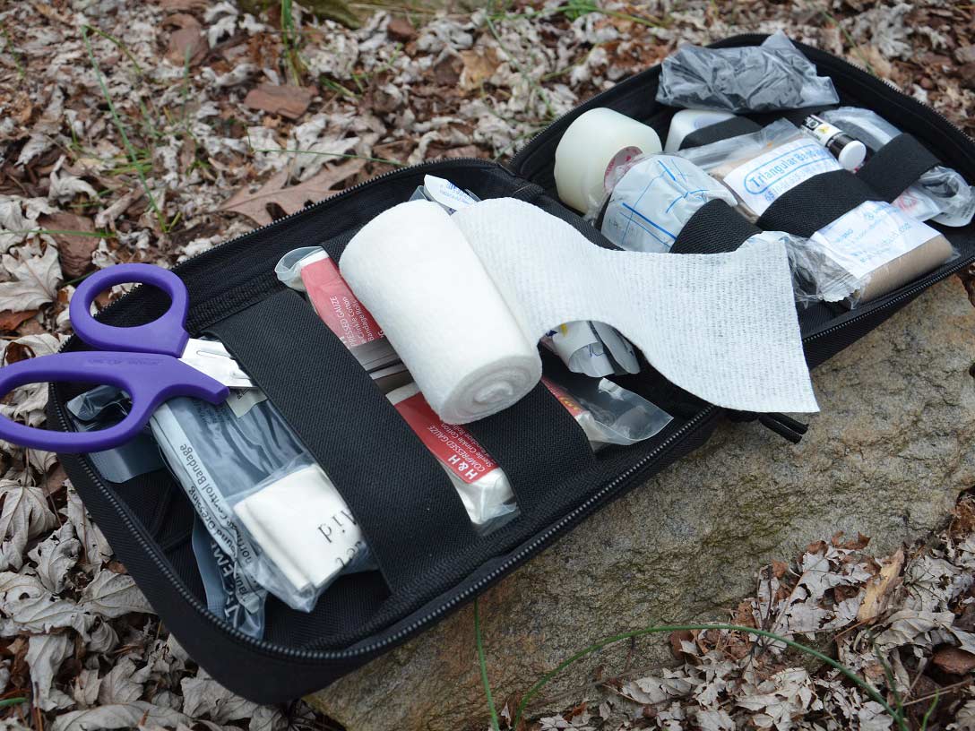 A collection of first aid supplies in a kit.