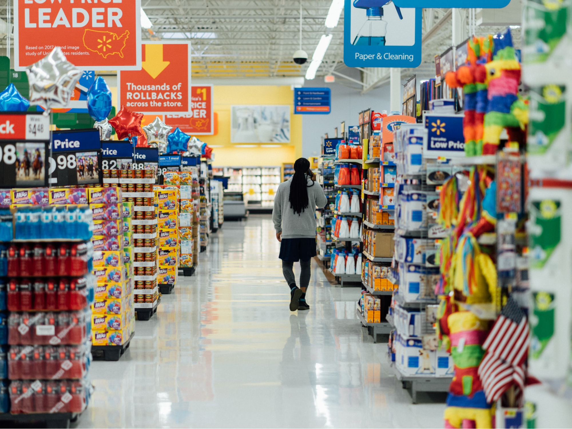 a person walking down an aisle in a store