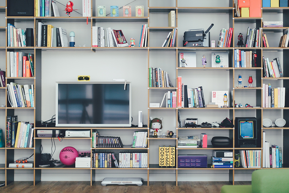 media console with gadgets, books, and a TV