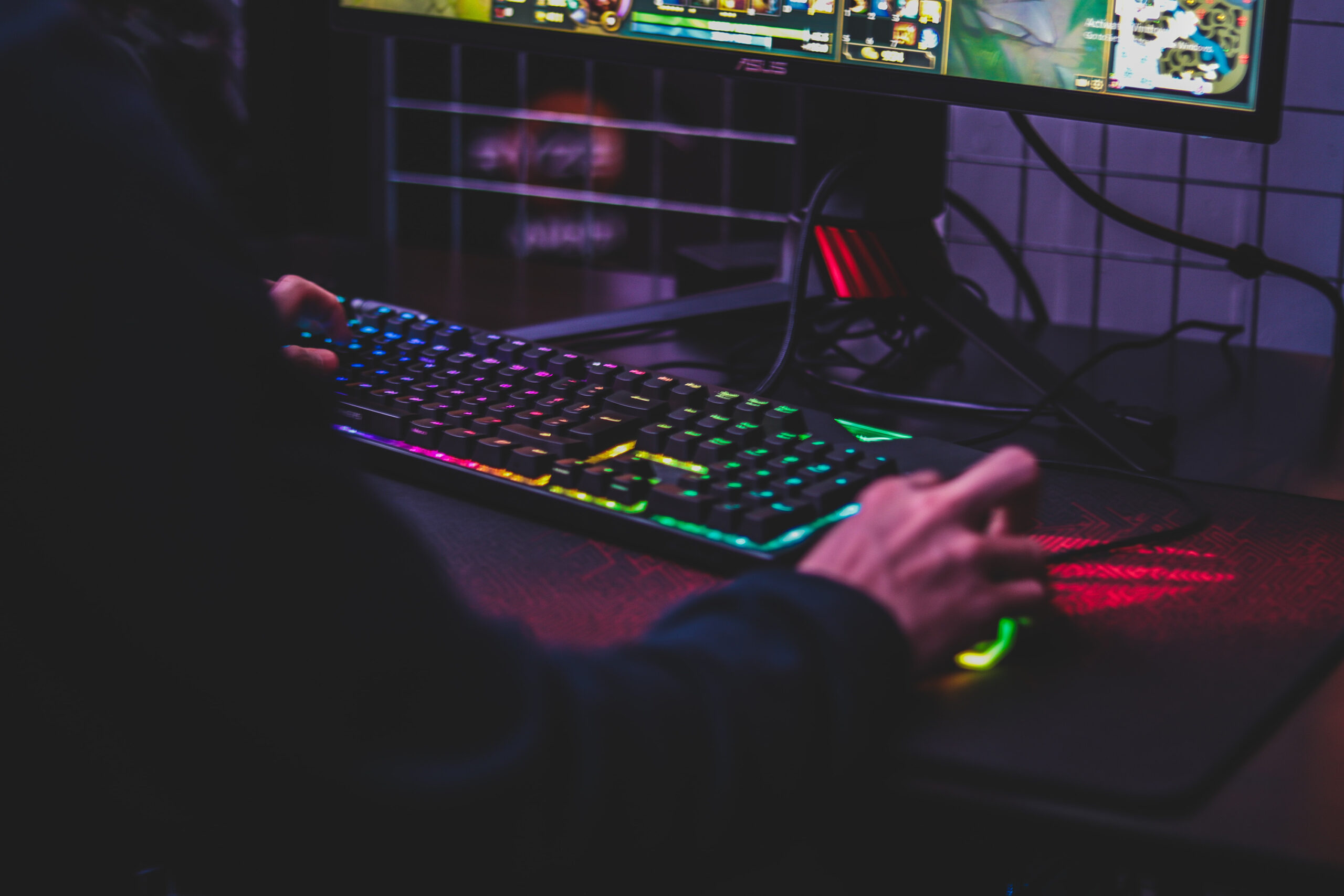 Person using a gaming mouse and ergonomic keyboard.